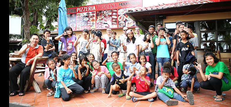 Children living with HIV/AIDS from The Camillian Social Center Rayong having a special lunch with the Italian captains.