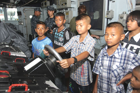 Children living with HIV/AIDS from The Camillian Social Center Rayong having a tour of Captain Scott Taits ship the USS Mustin. 